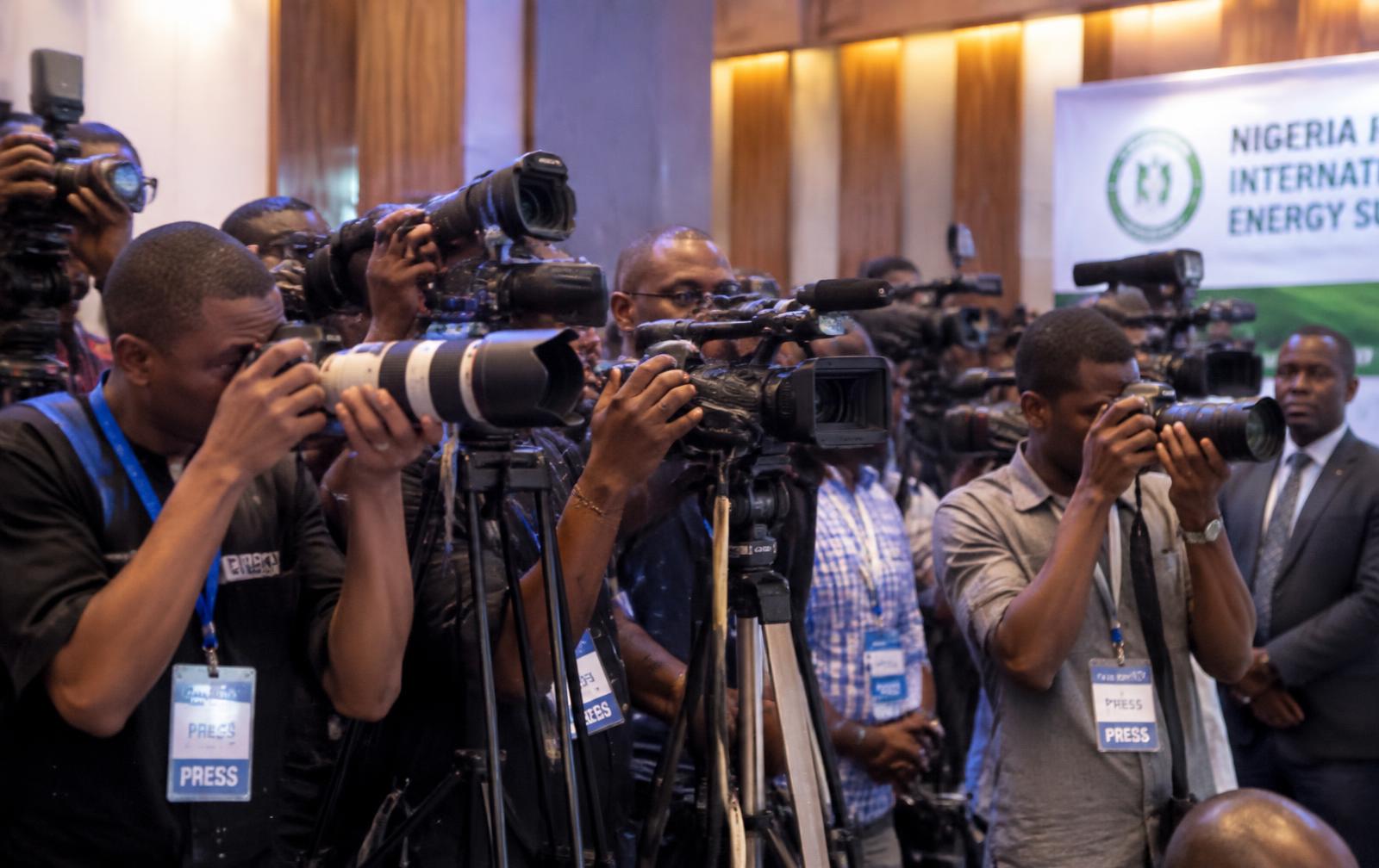 Press photographers and camera crews covering an event